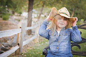 Cute Young Girl Wearing Cowboy Hat Posing for Portrait Outside