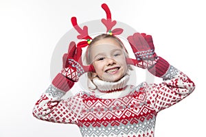 Cute young girl wearing deer horns. New year concept.