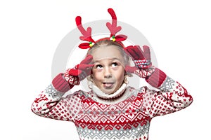 Cute young girl wearing deer horns. New year concept.