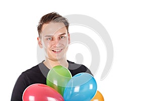 Cute young guy with colorful balloons