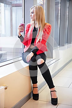 Cute young lady posing at the window