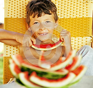 Cute young little boy with watermelon crustes smiling