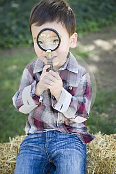 Cute Young Mixed Race Boy Looking Through Magnifying Glass