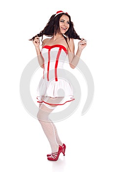 Cute young nurse looking aside