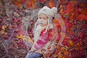 Cute young russian baby girl stylish dressed in warm white fur handmade jacket blue jeans boots and hooked hat teddy bear posing i photo