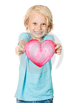 Cute young smiling boy holding love heart