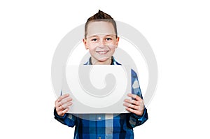 Cute young smiling schooler boy hold blank sign with copy space isolated on white background