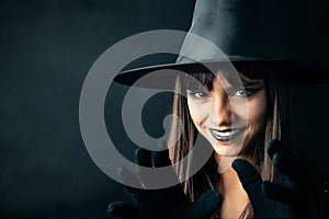 Cute young witch portrait making a spell