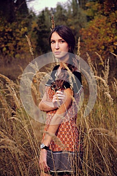 Cute young woman in the autumn field