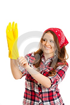 Cute young woman in checkered shirt with yellow rubber gloves re