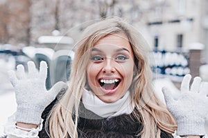 Cute young woman having fun and enjoing good weather in city. Winter holiday.