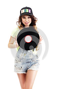 Cute Young Woman in Jeans Shorts holding Vinyl Record