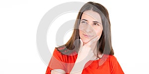 Cute young woman looking side pensive while posing against white copy space wall background