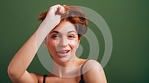 Cute young woman messing hair fun mood