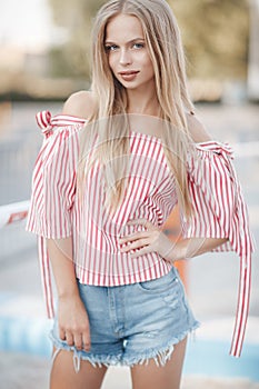 Cute young woman outdoors on a sunny day in summer