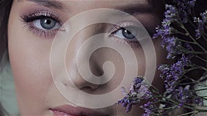 Cute young woman portrait close-up, fresh spring image with flowers.