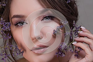 Cute young woman portrait close-up, fresh spring image with flowers. Beautiful girl.