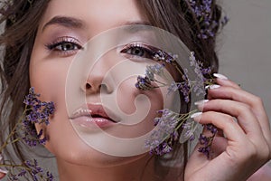 Cute young woman portrait close-up, fresh spring image with flowers. Beautiful girl.