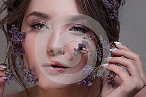 Cute young woman portrait close-up, fresh spring image with flowers. Beautiful girl