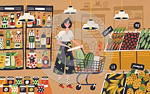 Cute young woman with shopping cart choosing and buying products at grocery store. Girl purchasing food at supermarket