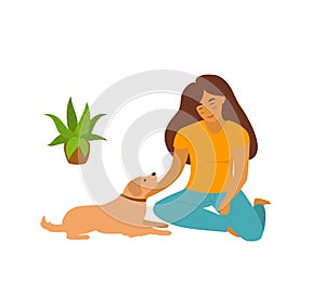 Cute young woman sitting with her pet dog on the floor at home