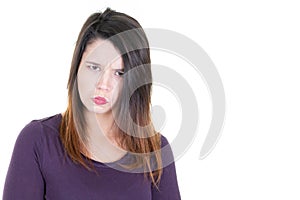 Cute young woman standing with disappointed irritated mood