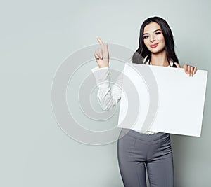 Cute young woman student with white blank paper banner