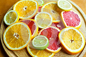 Cuted citrus fruits background. Mixed fruits background. Fruit salad