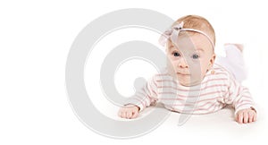 Cutest 4 month old caucasian baby girl with pink bow lying on white background  looking at camera  isolated.Copy space