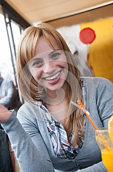 Cutest blond on earth sitting at table in coffee shop photo