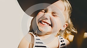 Cutest little girl smiling and squinting in sunlight. Happy toddler having fun. Portrait of playful child preschool age. Lifestyle