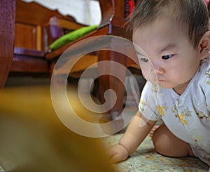 Cutie asian male baby very serious and look at tablet