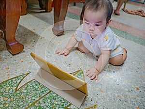 Cutie asian male baby very serious and look at tablet