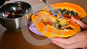Cuting papaya fruit open remove seed procedure