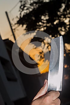 Cutlass knife with copy space and sunset in the background.