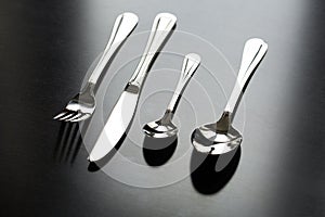 Cutlery on a black background. Fork, spoon, knife