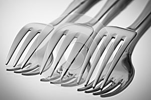 cutlery (forks) on a mirror in a black-and-white