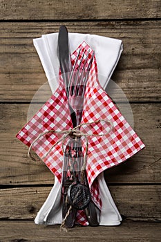 Cutlery with knife and fork plus a napkin in red white checked c