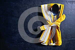 Cutlery and napkin on stone table. Table setting.