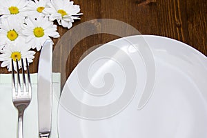 Cutlery and plate with flowers close up