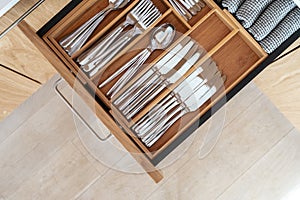 Cutlery set in bamboo trays in kitchen drawer