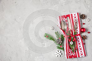 Cutlery set for Christmas dinner with holiday decorations on concrete table top view with copy space. flat lay