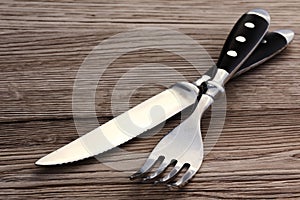 Cutlery set - fork and knife on wooden background