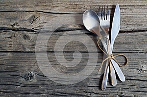 Cutlery set:fork,spoon and knife on rustic wooden table.Cutlery on old wooden background.Can be used as background menu for restau