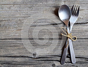 Cutlery set:fork and spoon on rustic wooden table.Cutlery on old wooden background.Can be used as background menu for restaurant.