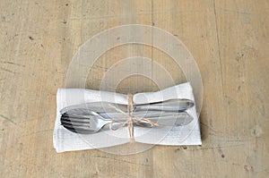 Cutlery suitable for dining. Knife, fork, spoon. On a wooden board. Suitable as a background.