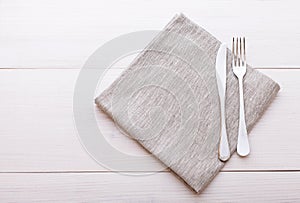 Cutlery, tablecloth on white wooden table for