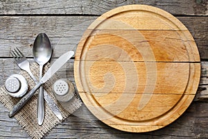 Cutlery and vintage empty cutting board food background