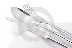 Cutlery on white empty plate isolated with clipping path