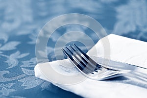 Cutlery on White Linen Over Brocade